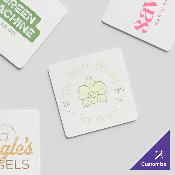 A group of white square paper coasters with green text and a flower logo.