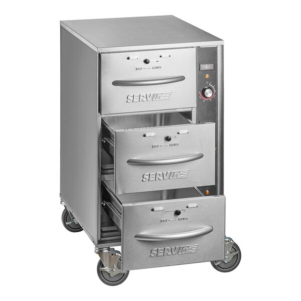 A stainless steel mobile triple narrow freestanding drawer warmer with three pull-out drawers and caster wheels.