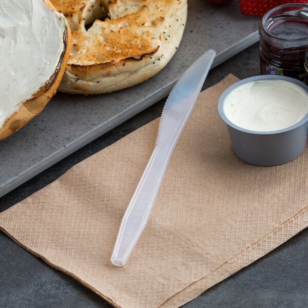 D&W polystyrene knife next to a bagel with cream cheese