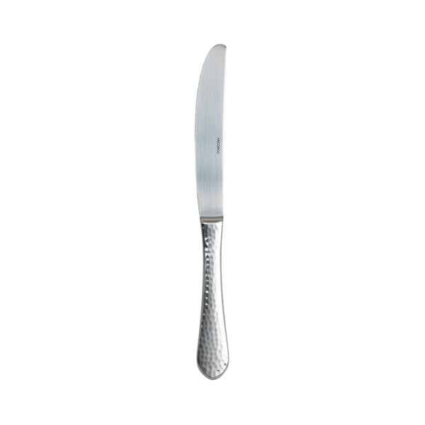 An Arcoroc stainless steel dinner knife with a textured handle.