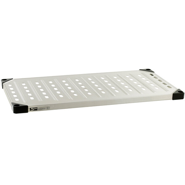 A white metal louvered shelf with holes.