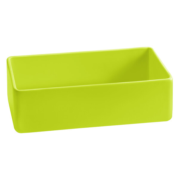 A lime green cast aluminum bowl with a white background.