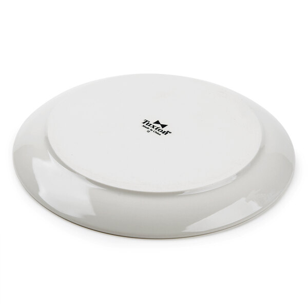 A white Tuxton china plate with black text on it.