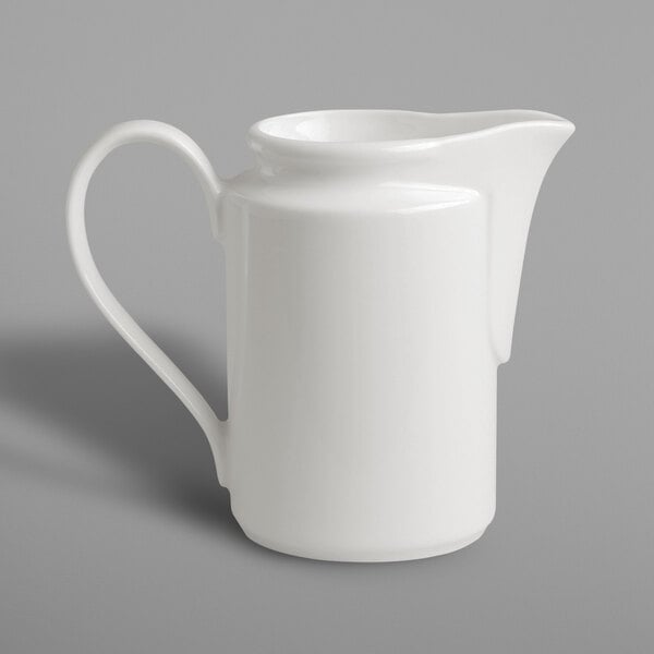 A RAK Porcelain ivory porcelain creamer with a handle.