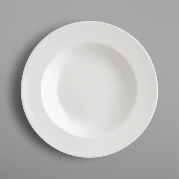A close-up of a RAK Porcelain ivory porcelain deep plate with a round rim.