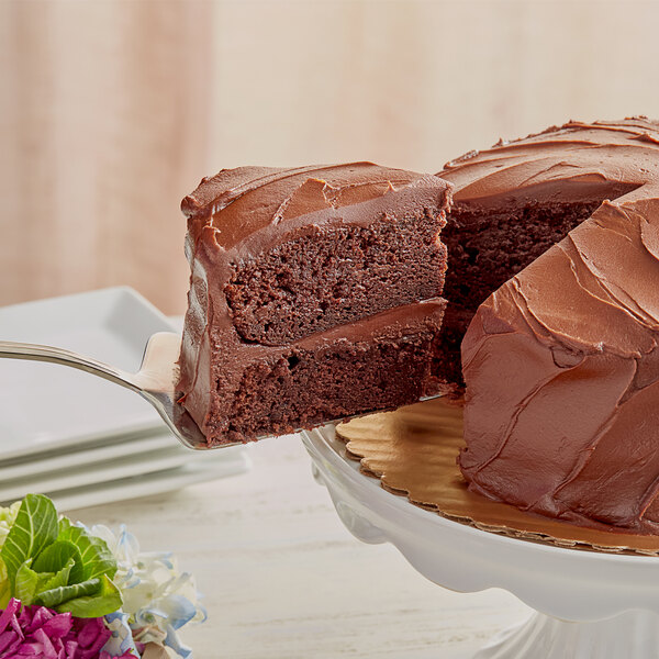 A slice of Devil's Food chocolate cake with chocolate frosting on a white plate.