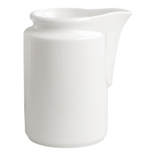 A small ivory porcelain creamer with a spout.