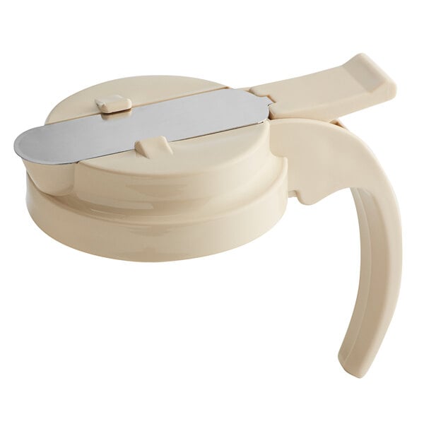 A cream colored plastic lid for a syrup server.