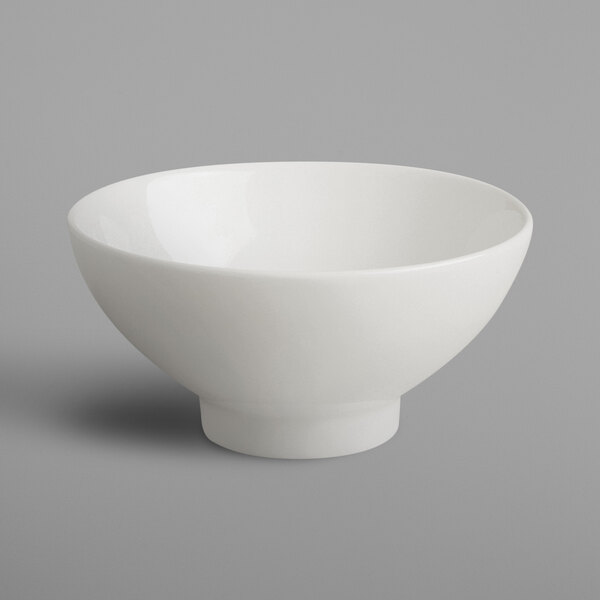 A RAK Porcelain ivory china bowl on a gray background.