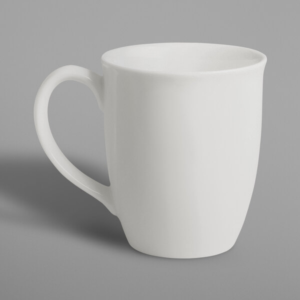 A RAK Porcelain ivory mug with a white handle on a white surface.