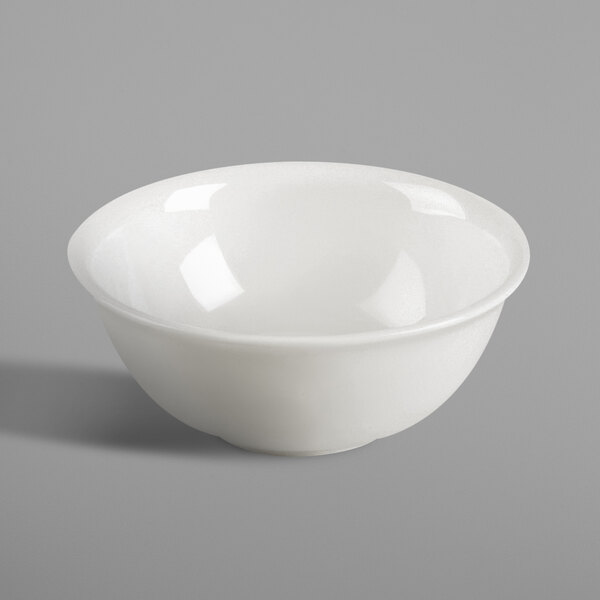 A RAK Porcelain ivory bowl on a gray surface.