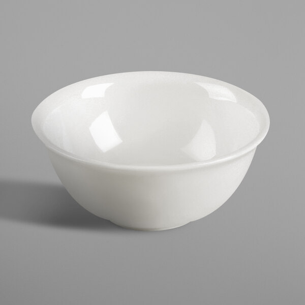 A RAK Porcelain ivory bowl filled with food on a white surface.