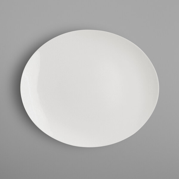 A RAK Porcelain ivory oval plate on a gray surface.