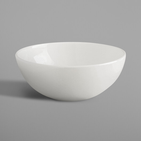 A RAK Porcelain ivory bowl on a gray surface.