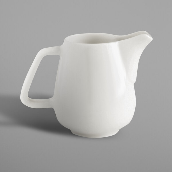 A white RAK Porcelain creamer with a handle.