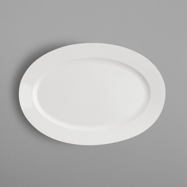 A RAK Porcelain ivory porcelain oval platter on a gray surface.