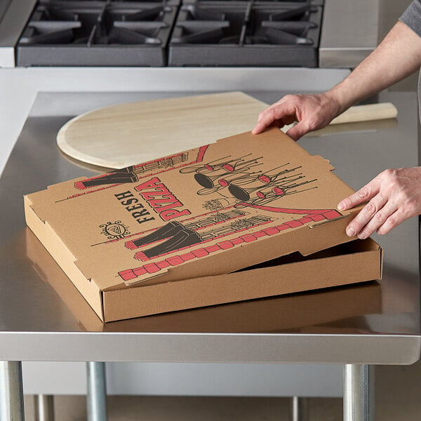 A person opening a Choice kraft corrugated pizza box on a table.