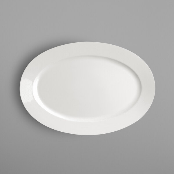 A RAK Porcelain ivory porcelain oval platter on a gray surface.
