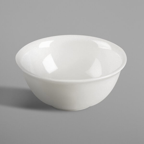 A RAK Porcelain ivory bowl on a gray surface.