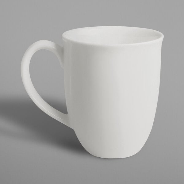 A RAK Porcelain ivory porcelain tulip mug with a white handle on a white surface.