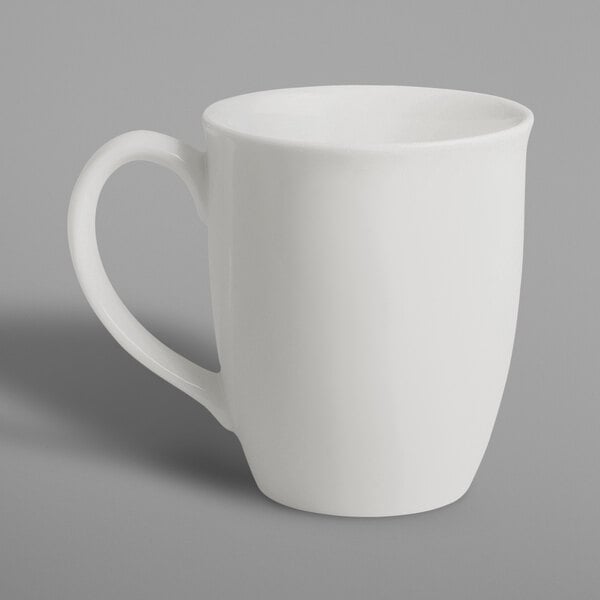 A RAK Porcelain ivory porcelain mug with a handle on a white surface.