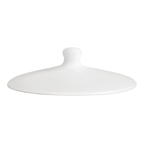 A white porcelain sugar bowl lid with a central knob handle.