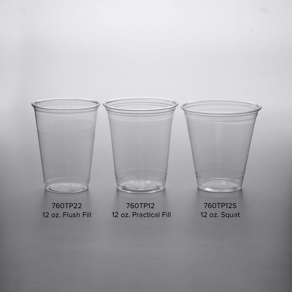 A row of clear Solo Ultra Clear plastic squat cups on a white surface.