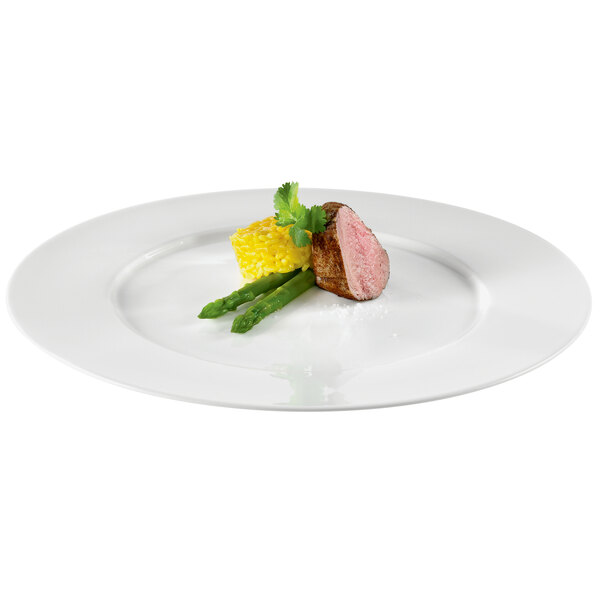 A RAK Porcelain ivory porcelain flat plate with a piece of meat and asparagus on it.