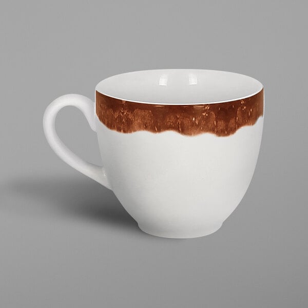 A white porcelain coffee cup with brown paint on it.