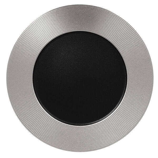 A black porcelain plate with silver embossed lines in a circular pattern.