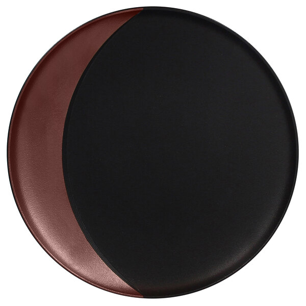 A black and brown RAK Porcelain deep plate with a bronze moon shape on a black surface.
