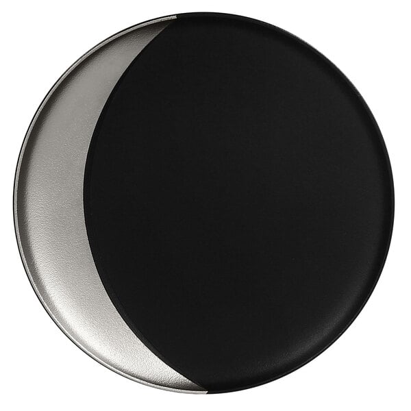 A RAK Porcelain black and silver porcelain deep plate with a moon shape.