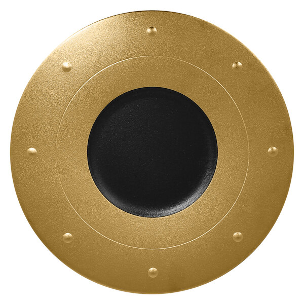 A gold porcelain plate with a black center.