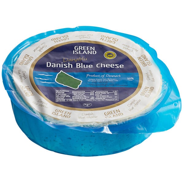 A blue round container with a white label that says "St. Clemens Green Island PGI Danish Crumbly Blue Cheese"