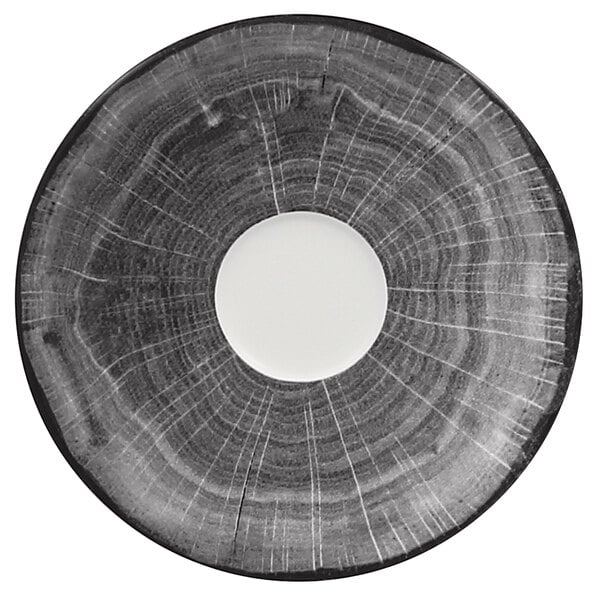 A circular beech grey porcelain saucer with a circular design and a hole in the center.