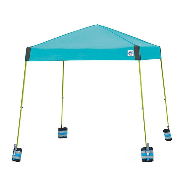 A blue E-Z Up canopy with weight bags on the legs.