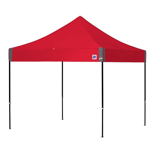 A red E-Z Up canopy with black poles and a white logo.