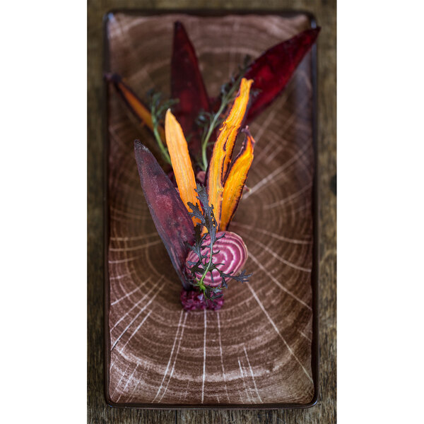 A RAK Porcelain Woodart oak brown rectangular serving platter with vegetables on it.