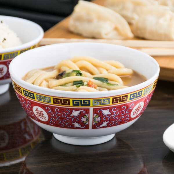 A Thunder Group Longevity melamine rice bowl filled with soup and noodles.