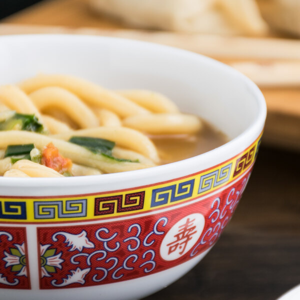 A Thunder Group Longevity melamine rice bowl filled with noodles and broth on a table.