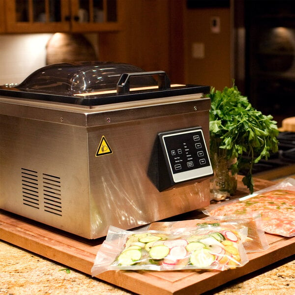 A Weston Pro-2500 vacuum packaging machine on a counter with a close-up of food.