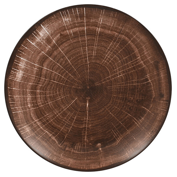 A brown porcelain flat coupe plate with a circular wood pattern.