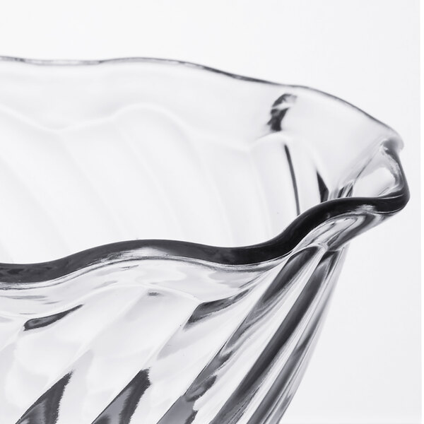 A clear glass tulip dessert dish with a wavy design.