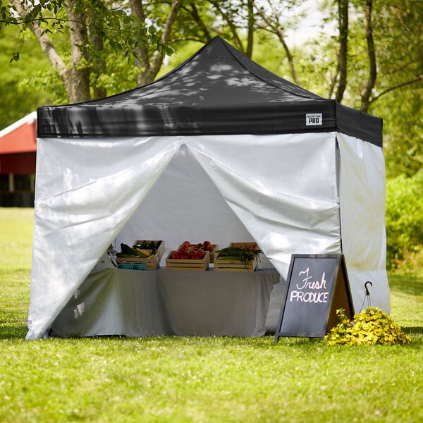 A black Backyard Pro canopy tent with white walls set up outdoors.