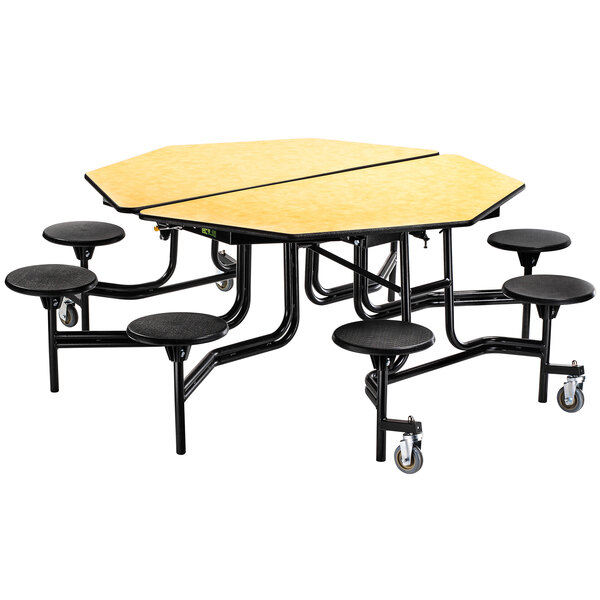 A black octagonal table with a wooden top and black metal frame with stools.