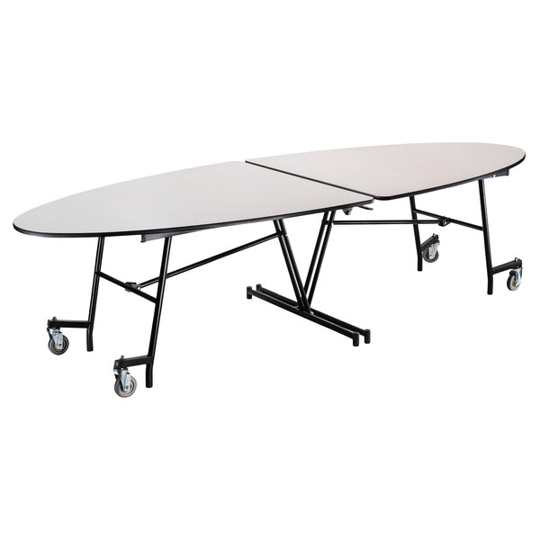 A white National Public Seating elliptical table with wheels and a chrome frame.