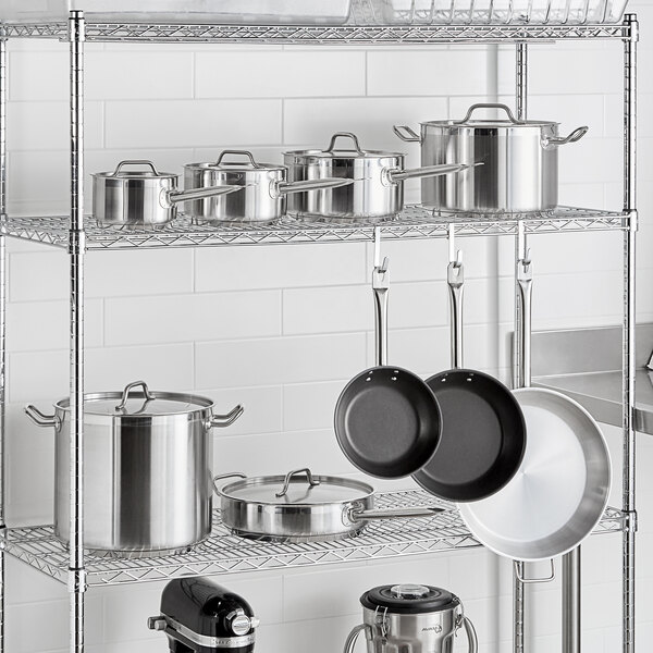 A metal rack with Vigor stainless steel pots and pans.