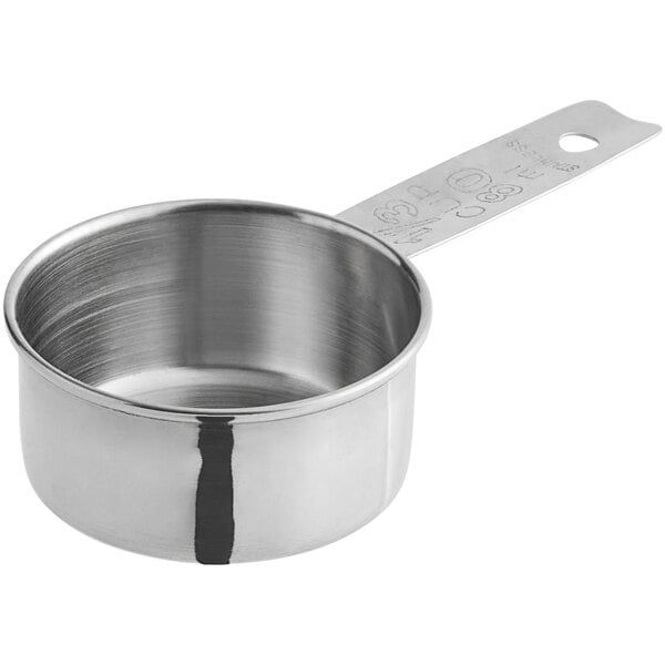A 1/3-cup metal measuring cup.