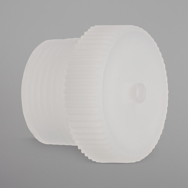 A white plastic Jackson threaded cap with a hole.