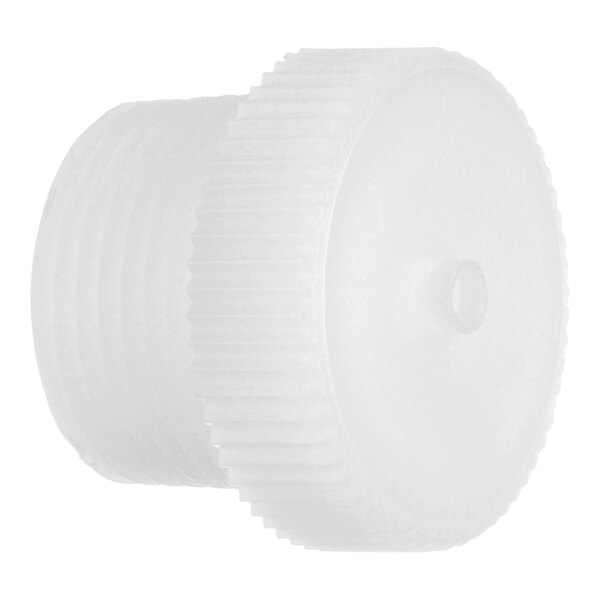 A close-up of a white plastic threaded cap with a hole.